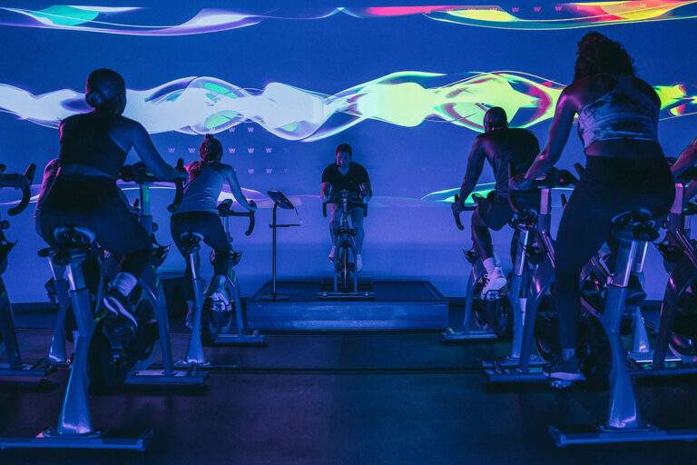 A spin studio with a screen visualizer in the background